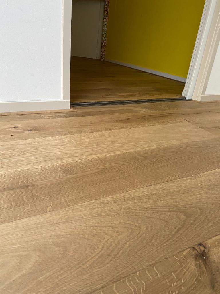 Er is een dilatatievoeg aan gehouden bij de overgang naar een slaapkamer in verband met de werking van de vloerplanken